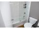 Bathroom with white tiled tub/shower combination and modern fixtures at 1081 Wirewood Dr # 302, Raleigh, NC 27605