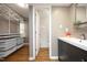 Bathroom with updated vanity, open shelving, and walk in closet at 1081 Wirewood Dr # 302, Raleigh, NC 27605