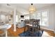 Open concept dining room with natural light and hardwood floors, adjacent to living room and kitchen at 1081 Wirewood Dr # 302, Raleigh, NC 27605