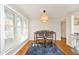 Dining area with natural light, hardwood floors, and a modern light fixture at 1081 Wirewood Dr # 302, Raleigh, NC 27605