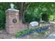 Welcoming entrance with brick signage and beautiful landscaping at 1081 Wirewood Dr # 302, Raleigh, NC 27605