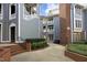 Beautiful exterior of a condo with light-gray siding, brick accents, and private balconies at 1081 Wirewood Dr # 302, Raleigh, NC 27605