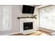 Elegant fireplace with a mantel, flanked by windows for natural light at 1081 Wirewood Dr # 302, Raleigh, NC 27605