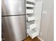 Kitchen featuring stainless steel refrigerator and pantry with pull-out shelves for easy storage at 1081 Wirewood Dr # 302, Raleigh, NC 27605