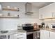 Bright kitchen featuring modern white cabinets, stainless steel appliances, and granite countertops with subway tile backsplash at 1081 Wirewood Dr # 302, Raleigh, NC 27605