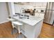 Kitchen island featuring bar stool seating, granite countertops, and a stainless steel sink at 1081 Wirewood Dr # 302, Raleigh, NC 27605