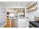 Bright kitchen with stainless steel appliances, stone countertops, and open shelving at 1081 Wirewood Dr # 302, Raleigh, NC 27605