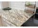 Close up of the granite countertop in the kitchen with white cabinets and stainless steel appliances at 1081 Wirewood Dr # 302, Raleigh, NC 27605