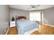 Bright main bedroom featuring a ceiling fan, light walls, wood floors and large window at 1081 Wirewood Dr # 302, Raleigh, NC 27605
