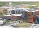 Aerial view of buildings including apartments and a Google building with visible street traffic at 110 N Corcoran St # 2502, Durham, NC 27701