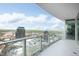 Spacious balcony overlooking city buildings with glass railings and blue skies at 110 N Corcoran St # 2502, Durham, NC 27701