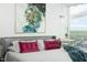 Modern bedroom with a grey headboard, soft bedding, a nightstand, and large window with city views at 110 N Corcoran St # 2502, Durham, NC 27701