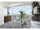 Bright bedroom with floor-to-ceiling windows offering city views and modern decor at 110 N Corcoran St # 2502, Durham, NC 27701