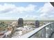Expansive city view from a high-rise balcony featuring modern architecture and blue skies at 110 N Corcoran St # 2502, Durham, NC 27701