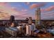 Multiple skyscrapers define the skyline as the sky is filled with color at dusk at 110 N Corcoran St # 2502, Durham, NC 27701
