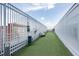 Enclosed dog run with artificial turf providing a safe and clean space for pets at 110 N Corcoran St # 2502, Durham, NC 27701
