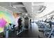 Bright fitness center featuring a variety of modern exercise equipment and vibrant wall art at 110 N Corcoran St # 2502, Durham, NC 27701