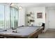 Well-lit game room, featuring a pool table, modern lighting, shelving, and artwork at 110 N Corcoran St # 2502, Durham, NC 27701