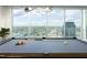 Modern game room with large windows that provide ample light, and a beautiful city view in the background at 110 N Corcoran St # 2502, Durham, NC 27701