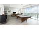 Large, modern game room with a pool table, comfortable seating, and beautiful views at 110 N Corcoran St # 2502, Durham, NC 27701