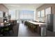 Modern kitchen with a large island, sleek appliances, bar seating, and scenic city views at 110 N Corcoran St # 2502, Durham, NC 27701