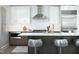A modern kitchen design with white cabinets, stainless steel appliances and a breakfast bar with stylish seating at 110 N Corcoran St # 2502, Durham, NC 27701