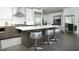 Modern kitchen featuring stainless steel appliances, white cabinets, and a center island with stylish seating at 110 N Corcoran St # 2502, Durham, NC 27701