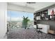 Office area featuring custom shelving, storage, and large windows with city views at 110 N Corcoran St # 2502, Durham, NC 27701