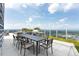 Outdoor dining space with seating for eight, stainless steel grills, and sweeping city views at 110 N Corcoran St # 2502, Durham, NC 27701