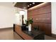 Reception area with a sleek desk, elegant wood paneling, and the inscription 