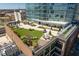 Rooftop deck offers green space with patio furniture, a firepit, plants, and modern high rise views at 110 N Corcoran St # 2502, Durham, NC 27701