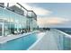 Stunning rooftop pool with city views, glass barriers, comfortable lounge chairs, and a relaxing atmosphere at 110 N Corcoran St # 2502, Durham, NC 27701