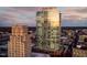 Skyscraper reflects a warm sunset, accentuating its height and modern design within the urban landscape at 110 N Corcoran St # 2502, Durham, NC 27701