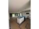 Open concept kitchen and living area with stainless steel appliances and backyard access at 1101 Brookrun Dr, Oxford, NC 27565