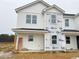 New two-story home featuring white siding and black roof is under construction at 1101 Brookrun Dr, Oxford, NC 27565