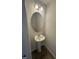 A charming bathroom with a pedestal sink, oval mirror, and modern light fixtures, creating a cozy space at 1102 Brookrun Dr, Oxford, NC 27565
