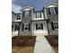 New townhome featuring stone accents, black shutters, and a welcoming entrance in a well-lit neighborhood at 1102 Brookrun Dr, Oxford, NC 27565