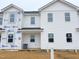 New construction home features white vinyl siding and traditional architectural details in a modern design at 1102 Brookrun Dr, Oxford, NC 27565