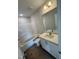 Bathroom with white cabinets, a tub-shower combo, and neutral tiling at 1103 Brookrun Dr, Oxford, NC 27565