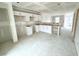 The new kitchen features unfinished drywall, cabinets and a bare floor at 1103 Brookrun Dr, Oxford, NC 27565