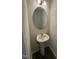 Half bath with pedestal sink, oval mirror, and modern light fixture at 1104 Brookrun Dr, Oxford, NC 27565