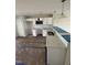 Modern kitchen with stainless steel appliances, white cabinets, and quartz countertops at 1104 Brookrun Dr, Oxford, NC 27565