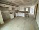 Unfinished kitchen featuring white cabinets, drywall, and an open layout, ready for customization at 1104 Brookrun Dr, Oxford, NC 27565