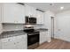 Modern kitchen featuring stainless steel appliances, granite countertops, and white cabinetry at 12 Crow Field St, Roxboro, NC 27574
