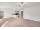 Living room with carpet flooring flows into the adjacent kitchen with white cabinetry at 12 Crow Field St, Roxboro, NC 27574