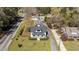 An elevated view showcasing a white home, neat landscaping, and a private driveway at 1310 S 8Th St, Lillington, NC 27546