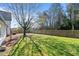 Lush, fenced backyard with vibrant green grass, mature trees, and ample space for outdoor activities and recreation at 1310 S 8Th St, Lillington, NC 27546