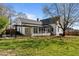 Expansive backyard with lush green grass, mature tree, and black awning, ideal for outdoor activities at 1310 S 8Th St, Lillington, NC 27546