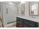 Stylish bathroom with double vanity, framed mirrors, and modern shower with hexagon tile at 1310 S 8Th St, Lillington, NC 27546