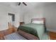 Bright bedroom with hardwood floors, ceiling fan, neutral walls, and a decorative rug at 1310 S 8Th St, Lillington, NC 27546